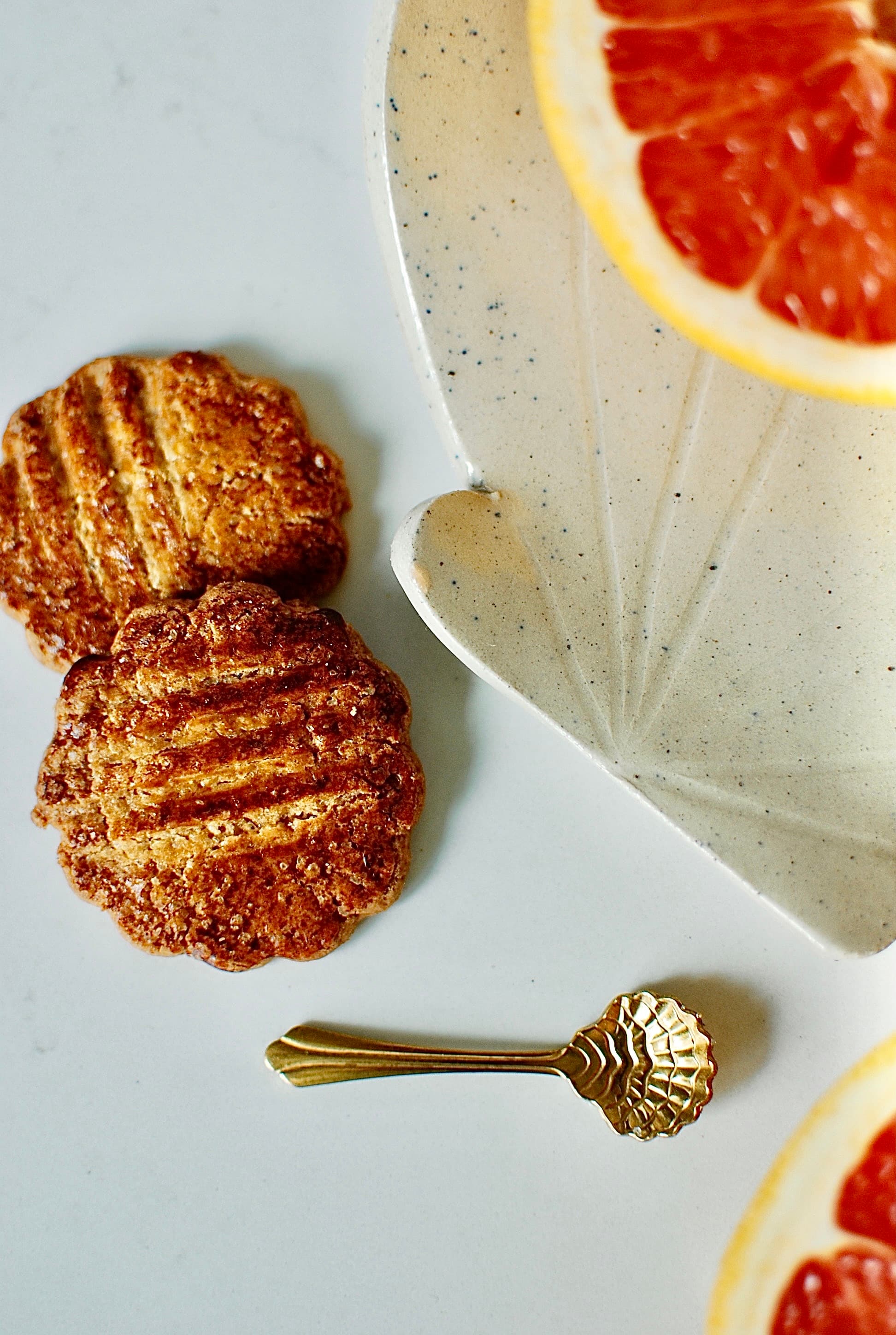 Scallop-shaped stoneware plate styled with biscuits and a gold spoon, handmade ceramic trinket dish β Sable collection, Studio Lippi Ceramics in Dublin