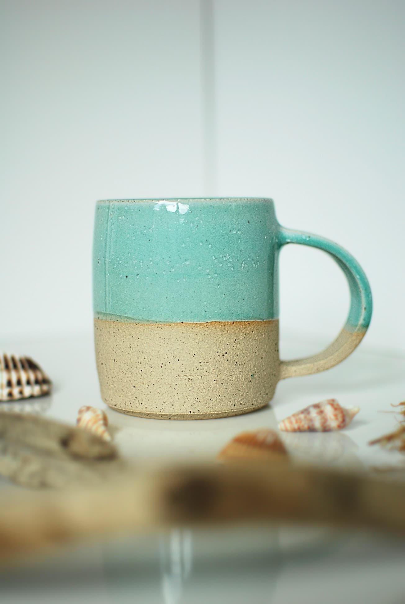 Handmade stoneware mug with turquoise glaze, speckled natural clay base, wheel-thrown by Studio Lippi Ceramics, in Dublin.